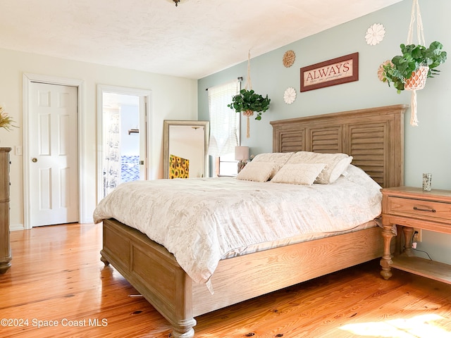 bedroom featuring a textured ceiling and light wood-type flooring