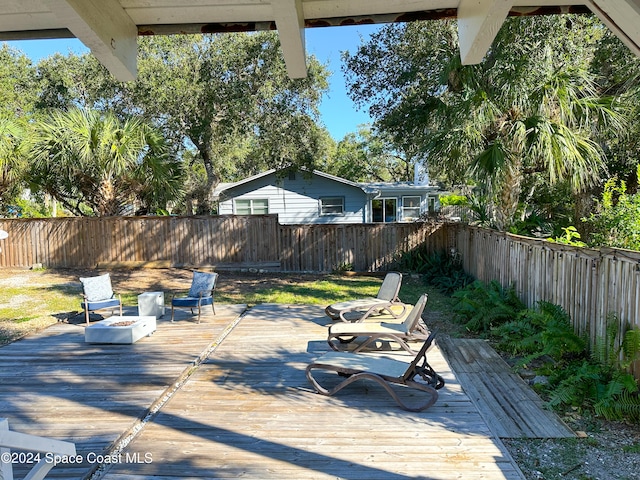 view of patio with an outdoor fire pit and a wooden deck