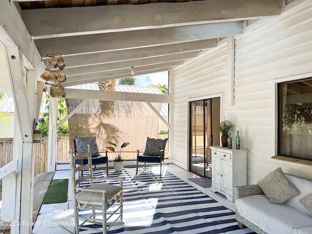 sunroom featuring lofted ceiling