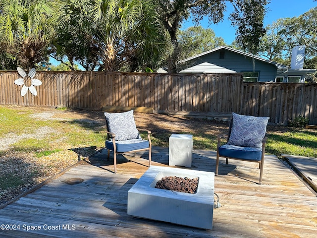 wooden terrace featuring a fire pit