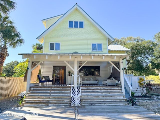 back of house featuring covered porch