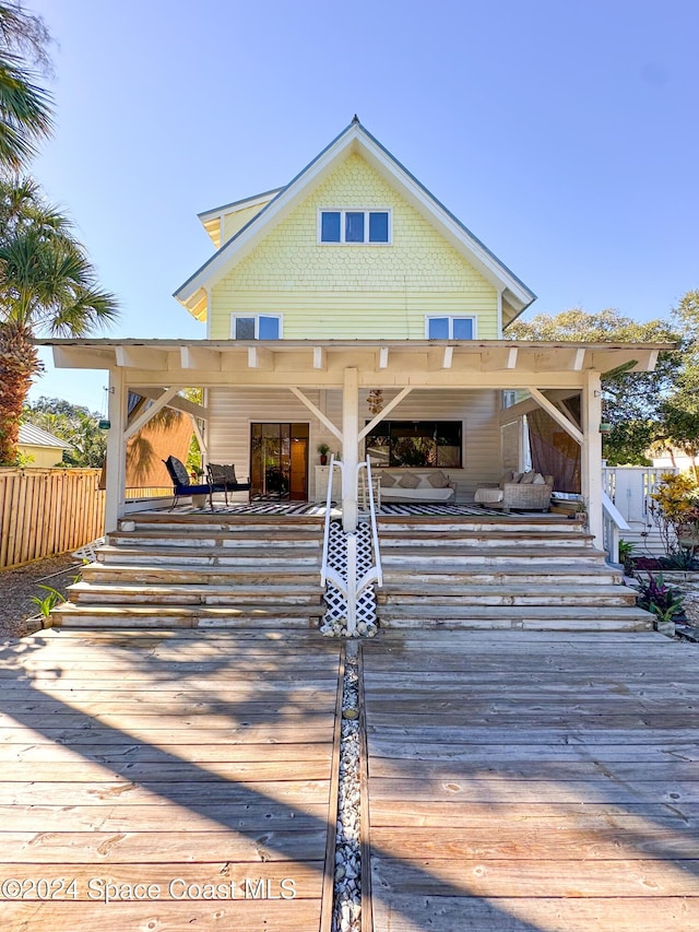 5875 Riverside Dr, Melbourne Beach, FL 32951 - rear view of property featuring a wooden deck