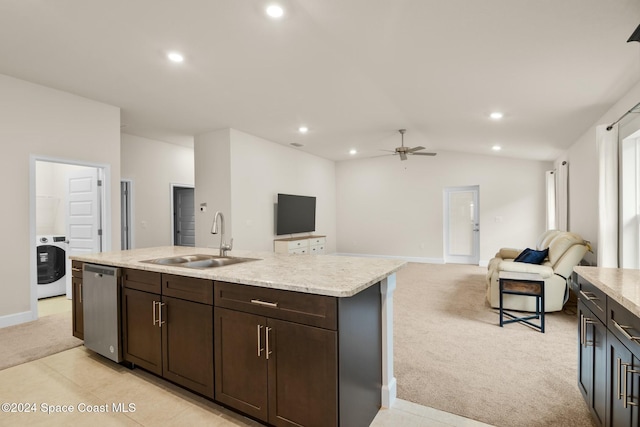 kitchen with washer / clothes dryer, sink, light colored carpet, and vaulted ceiling