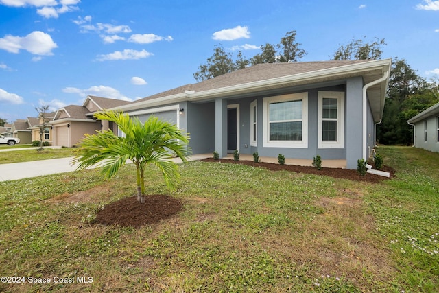 single story home featuring a garage and a front lawn