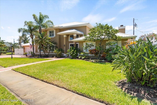 view of front of home with a garage and a front yard