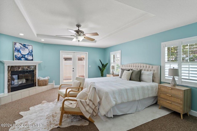 bedroom with ceiling fan, carpet floors, and multiple windows