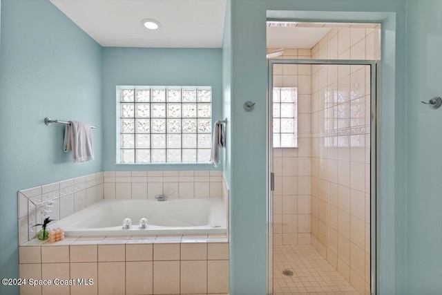 bathroom featuring shower with separate bathtub