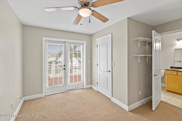 interior space featuring access to outside, ensuite bath, ceiling fan, and french doors