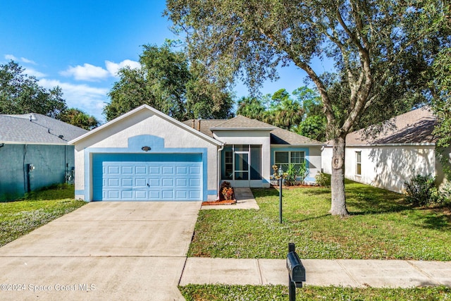 ranch-style home with a garage and a front yard