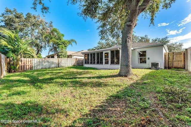 view of yard featuring central AC and a sunroom