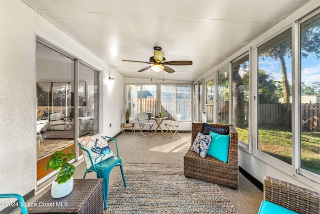 sunroom featuring ceiling fan