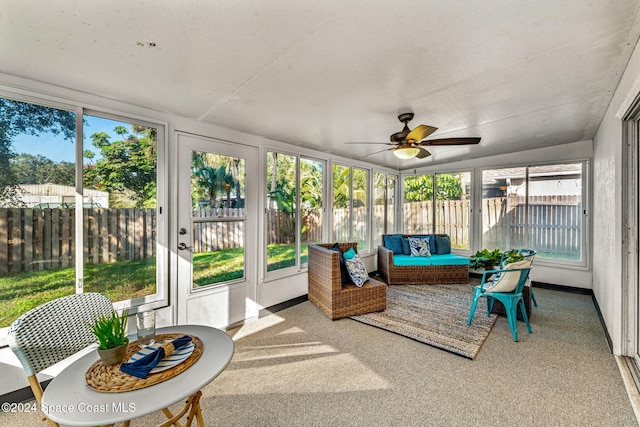 sunroom with ceiling fan, a healthy amount of sunlight, and vaulted ceiling