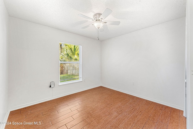 unfurnished room with hardwood / wood-style floors, ceiling fan, and a textured ceiling