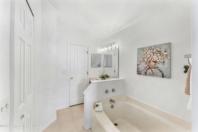 bathroom featuring tile patterned flooring, vanity, a tub to relax in, and vaulted ceiling