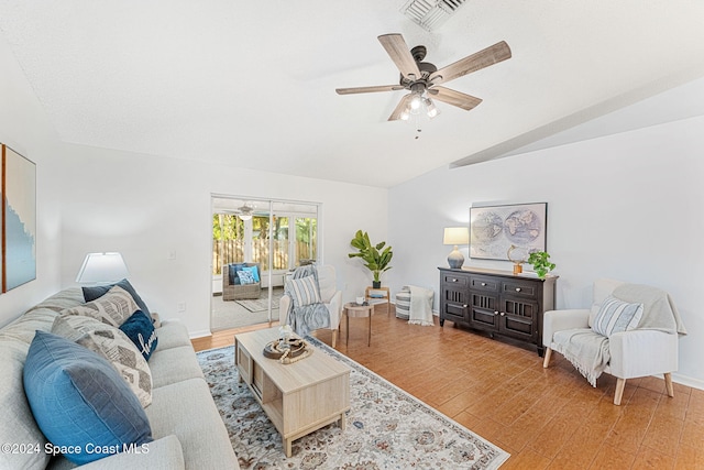 living room featuring ceiling fan, hardwood / wood-style floors, and vaulted ceiling