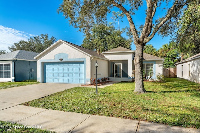 ranch-style house with a sunroom, a garage, and a front yard