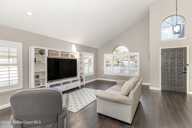 living room with a chandelier, dark hardwood / wood-style flooring, and high vaulted ceiling