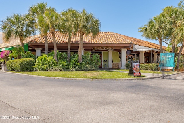 mediterranean / spanish-style house featuring a front lawn