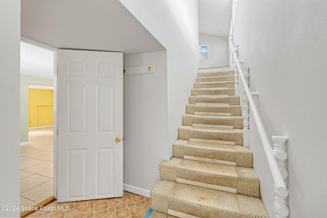 stairway featuring tile patterned floors