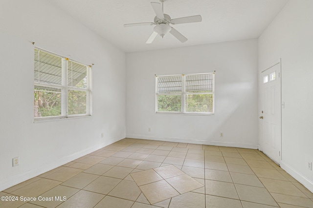 spare room featuring ceiling fan and light tile patterned flooring