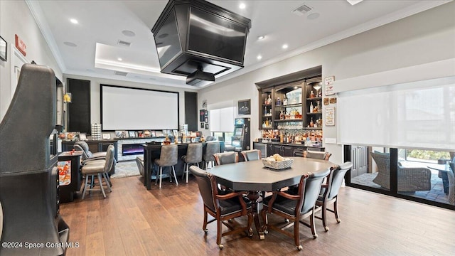 dining space with crown molding and hardwood / wood-style floors