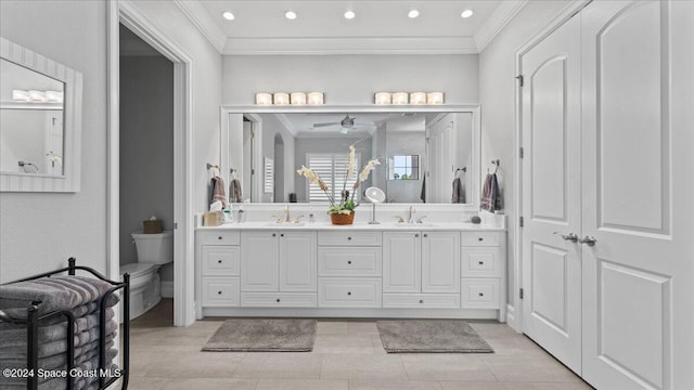 bathroom featuring vanity, tile patterned floors, crown molding, ceiling fan, and toilet