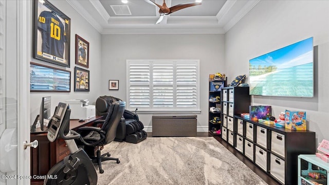 office featuring hardwood / wood-style flooring, ceiling fan, ornamental molding, and a tray ceiling