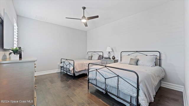 bedroom featuring dark hardwood / wood-style flooring and ceiling fan