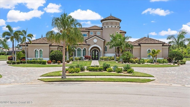 4695 Tea Tree Ct, Rockledge, FL 32955 - mediterranean / spanish-style house featuring curved driveway, stucco siding, and a tile roof