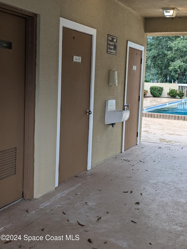 doorway to property featuring a fenced in pool and a patio