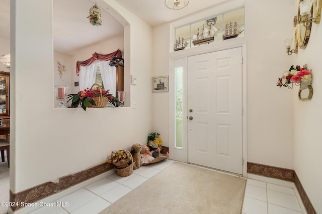 entryway with a healthy amount of sunlight and light tile patterned flooring