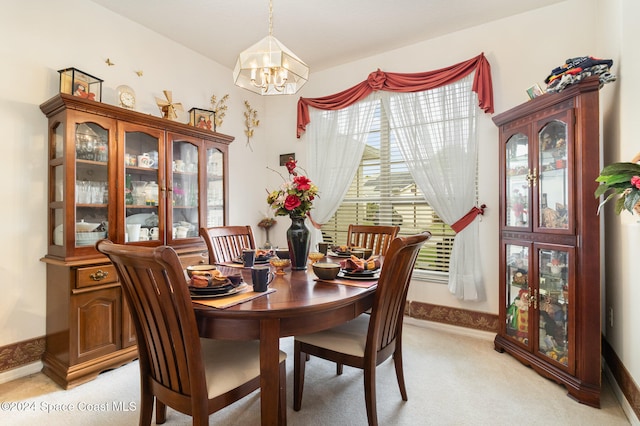 carpeted dining area featuring a notable chandelier