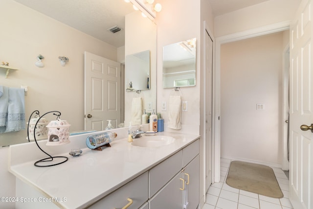 bathroom with tile patterned floors and vanity