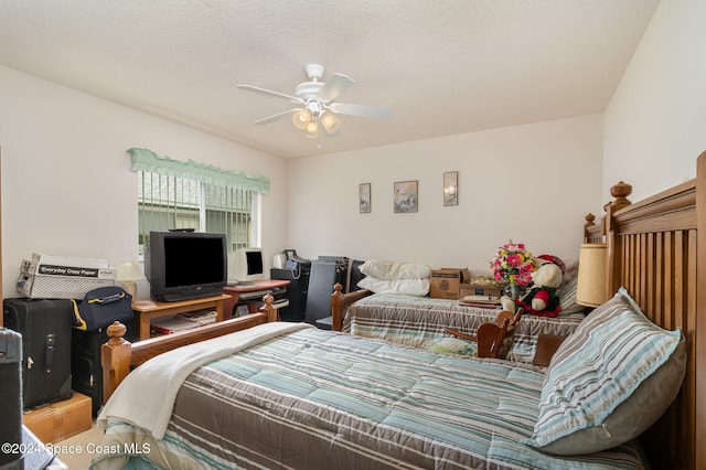 bedroom featuring a textured ceiling and ceiling fan