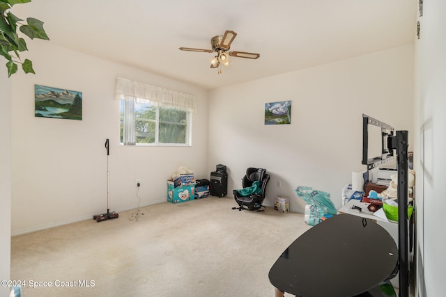 misc room with carpet flooring and ceiling fan