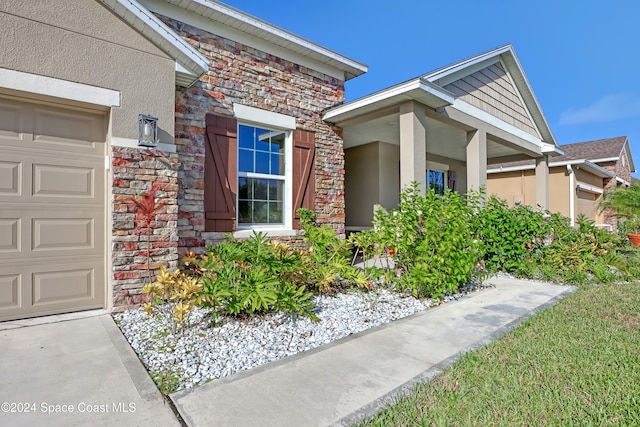 view of exterior entry with a garage