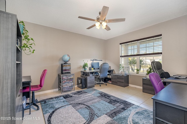 tiled home office featuring ceiling fan