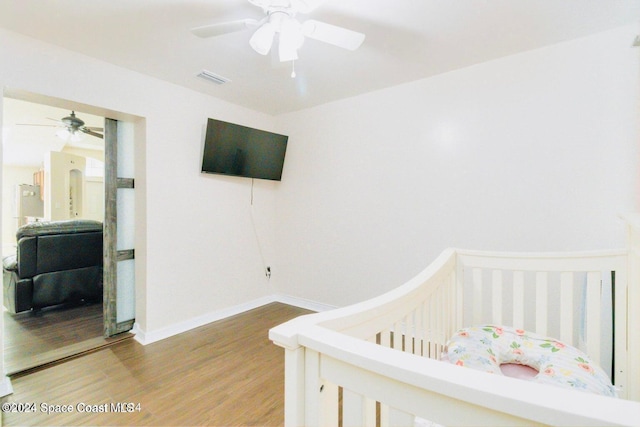 458 Barcelona Rd SE, Palm Bay, FL 32909 - bedroom featuring wood finished floors, baseboards, a nursery area, and ceiling fan