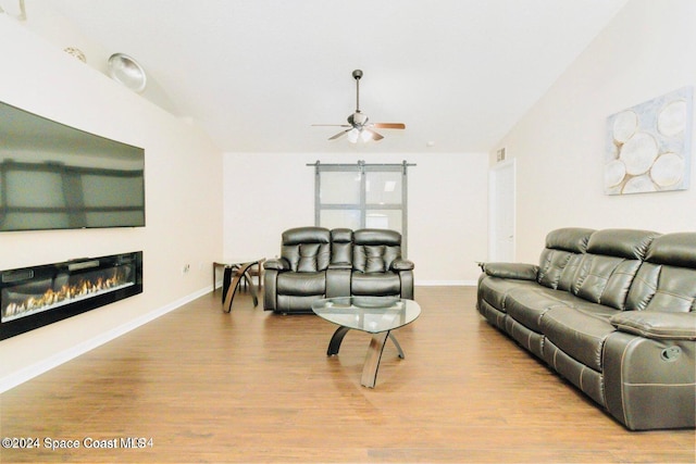 living room featuring ceiling fan and light hardwood / wood-style floors