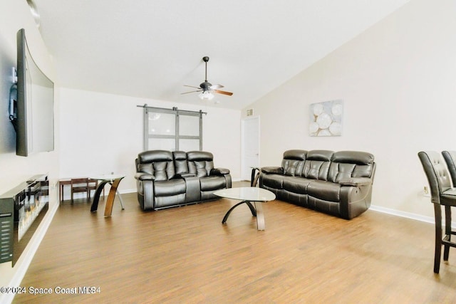 living room with ceiling fan, lofted ceiling, and light hardwood / wood-style floors