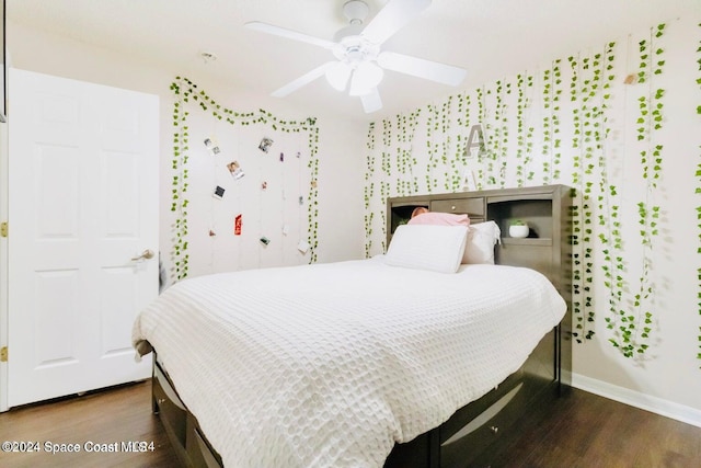 bedroom with ceiling fan and dark hardwood / wood-style floors