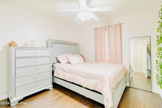 bedroom with ceiling fan and light hardwood / wood-style flooring