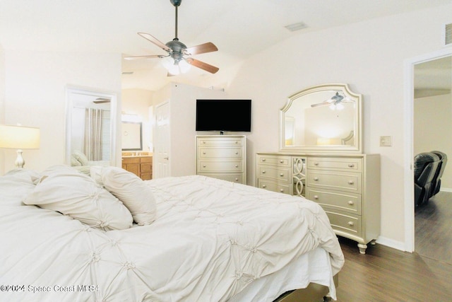 bedroom featuring lofted ceiling, ceiling fan, dark hardwood / wood-style floors, and ensuite bathroom