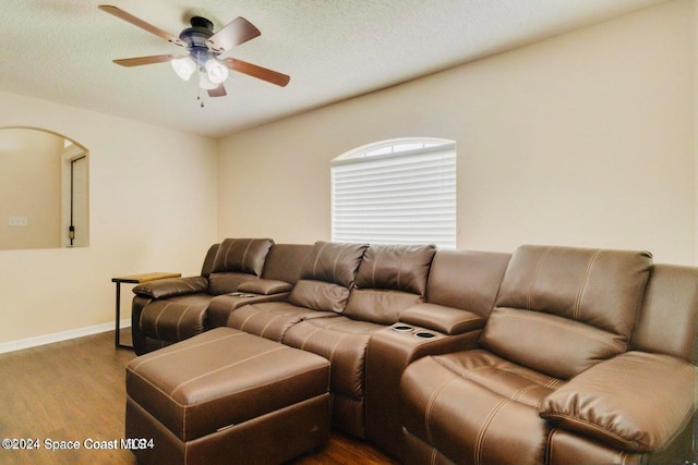 living room with hardwood / wood-style flooring, a textured ceiling, and ceiling fan