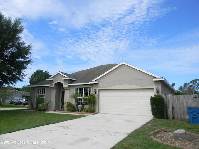 ranch-style home with a front yard and a garage