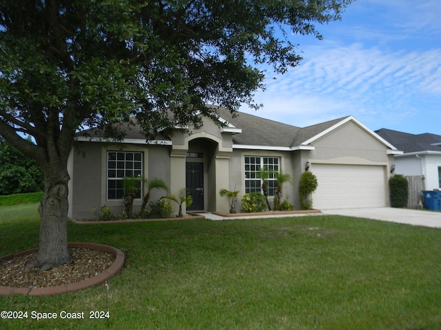 ranch-style house with a garage and a front lawn