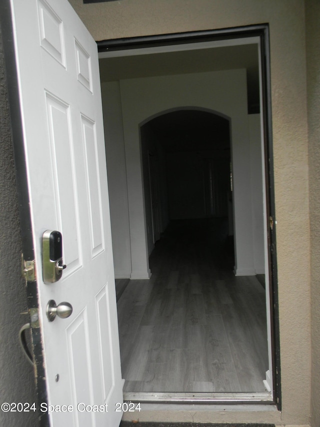 corridor featuring hardwood / wood-style floors