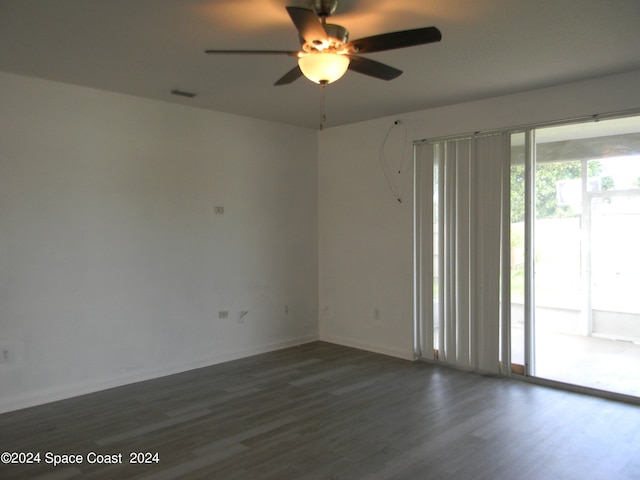 spare room with dark hardwood / wood-style floors and ceiling fan