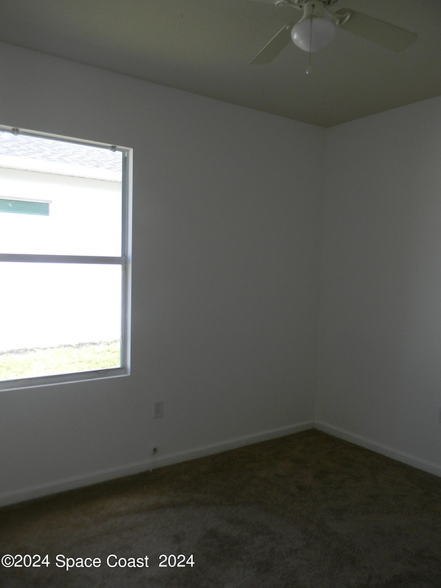 carpeted spare room with ceiling fan