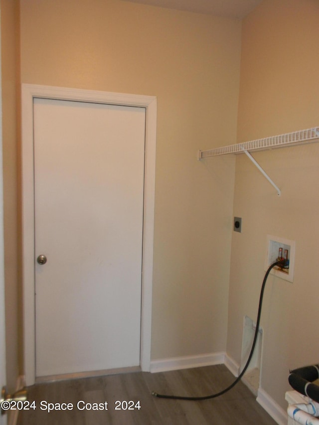 laundry room with washer hookup and hardwood / wood-style flooring